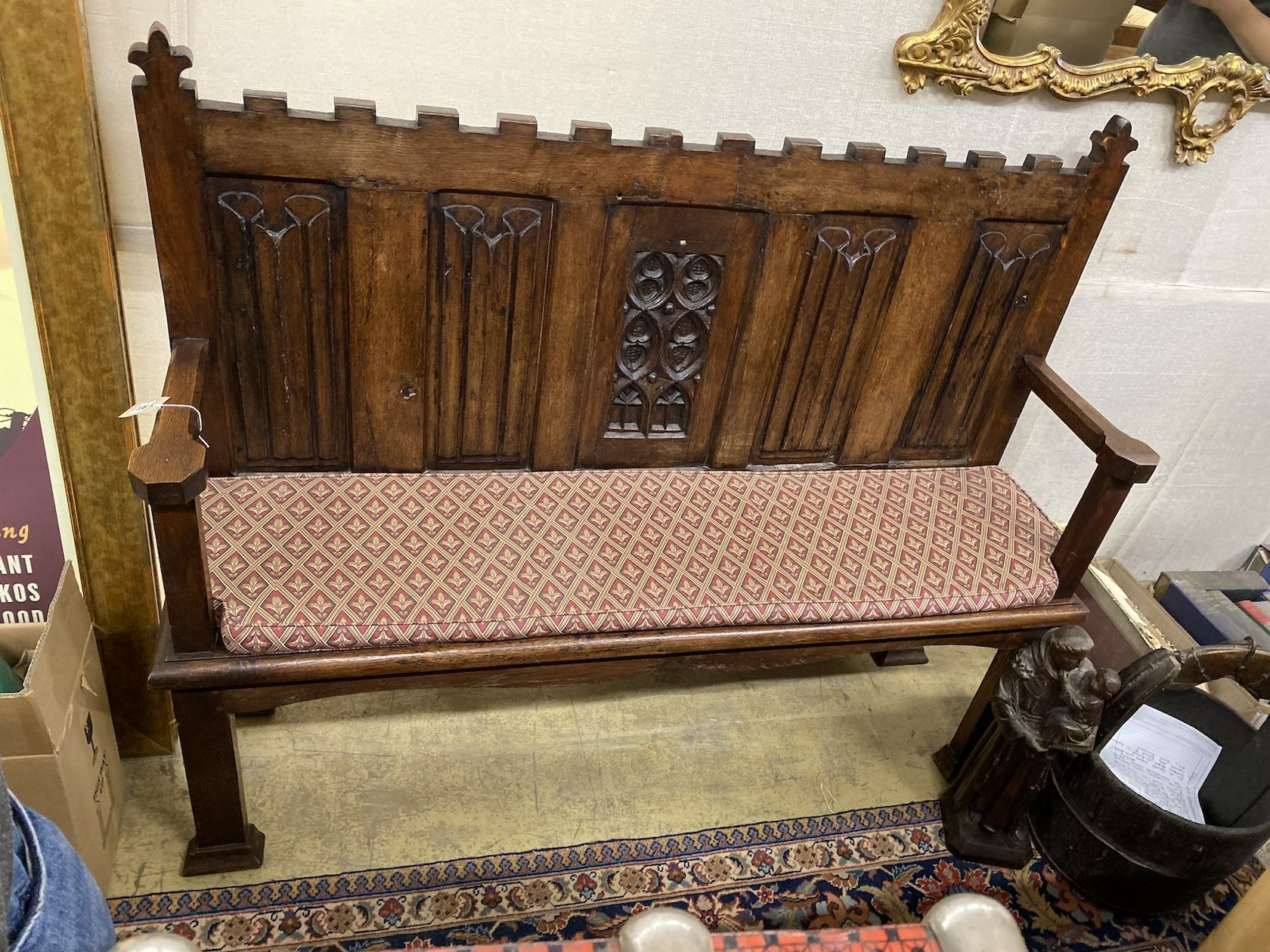 An early 20th century 17th century style carved oak settle, length 143cm, depth 37cm, height 119cm